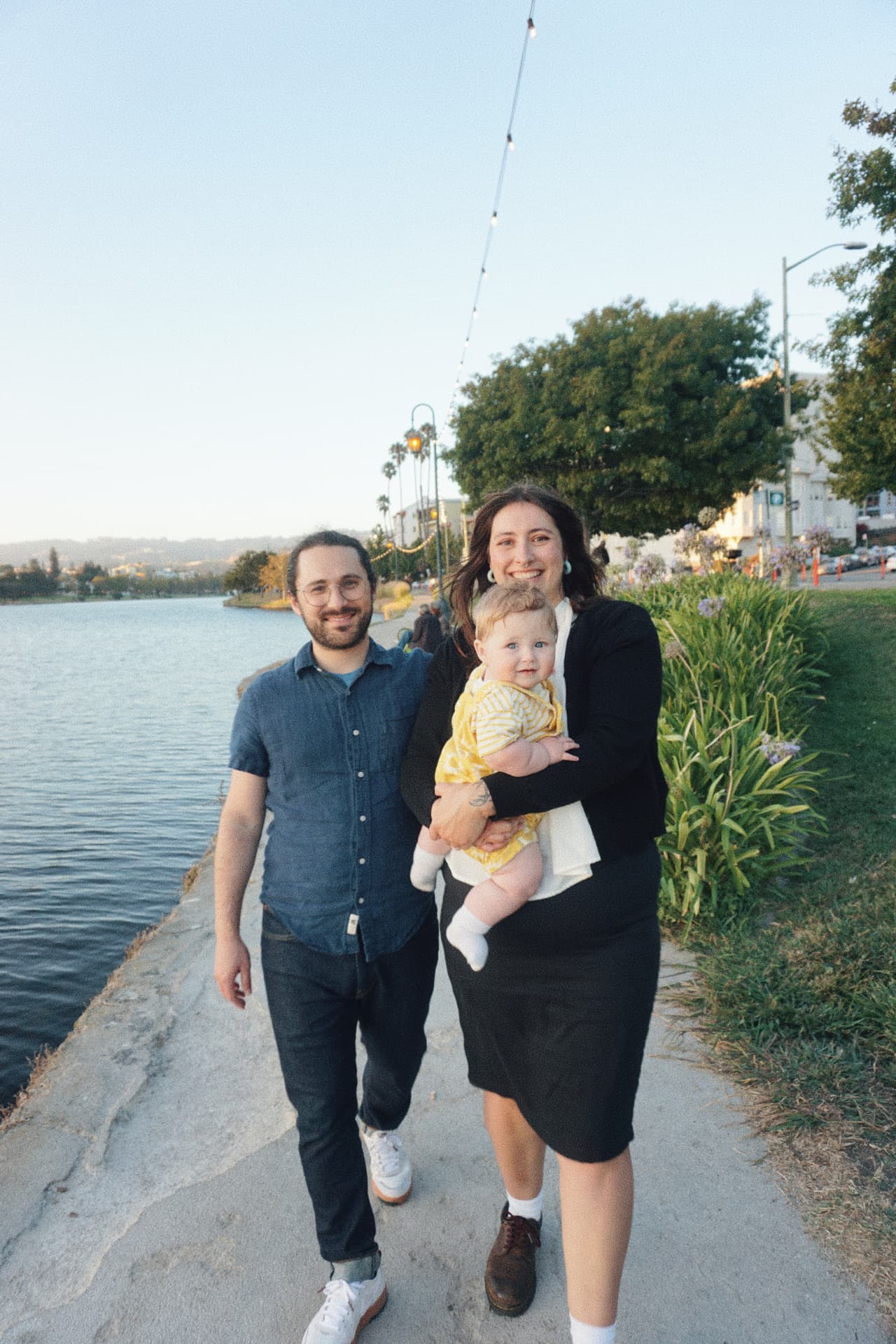 The Espicha-Blumenstein family walking along the Lake Merritt path together at sunset