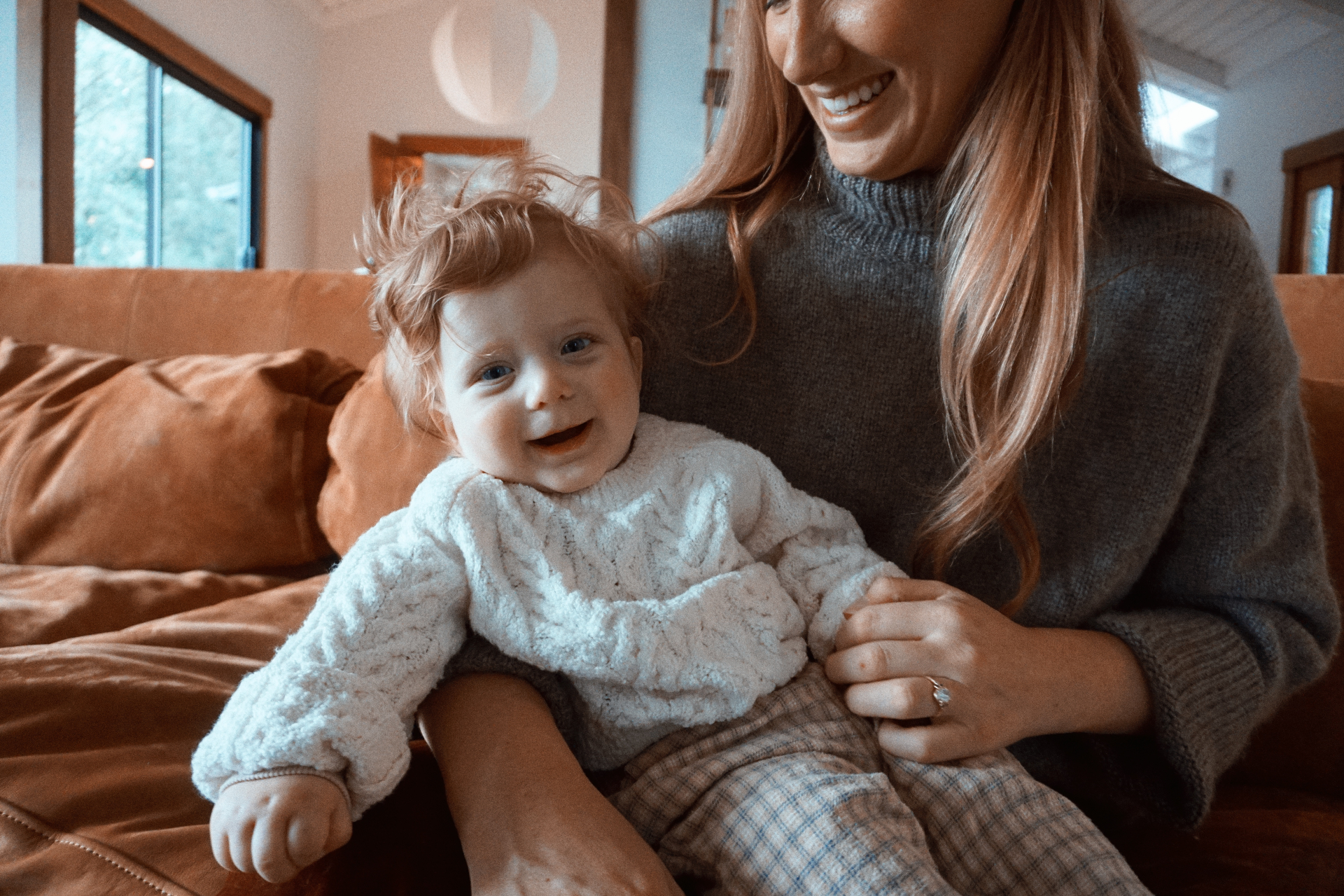The Fleischmann family sharing a warm at-home moment on the couch
