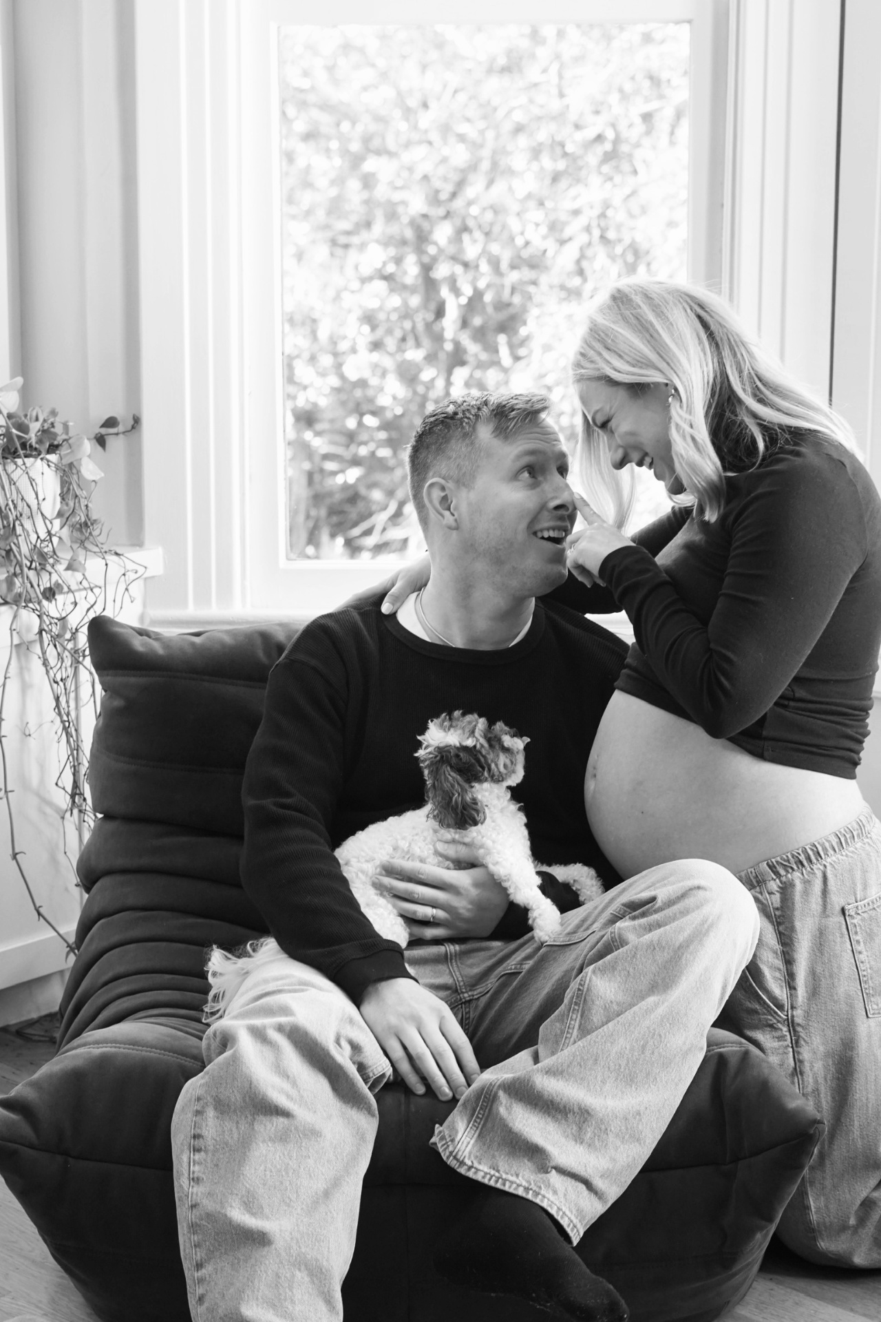 The Parson family laughing together during an at-home maternity photoshoot