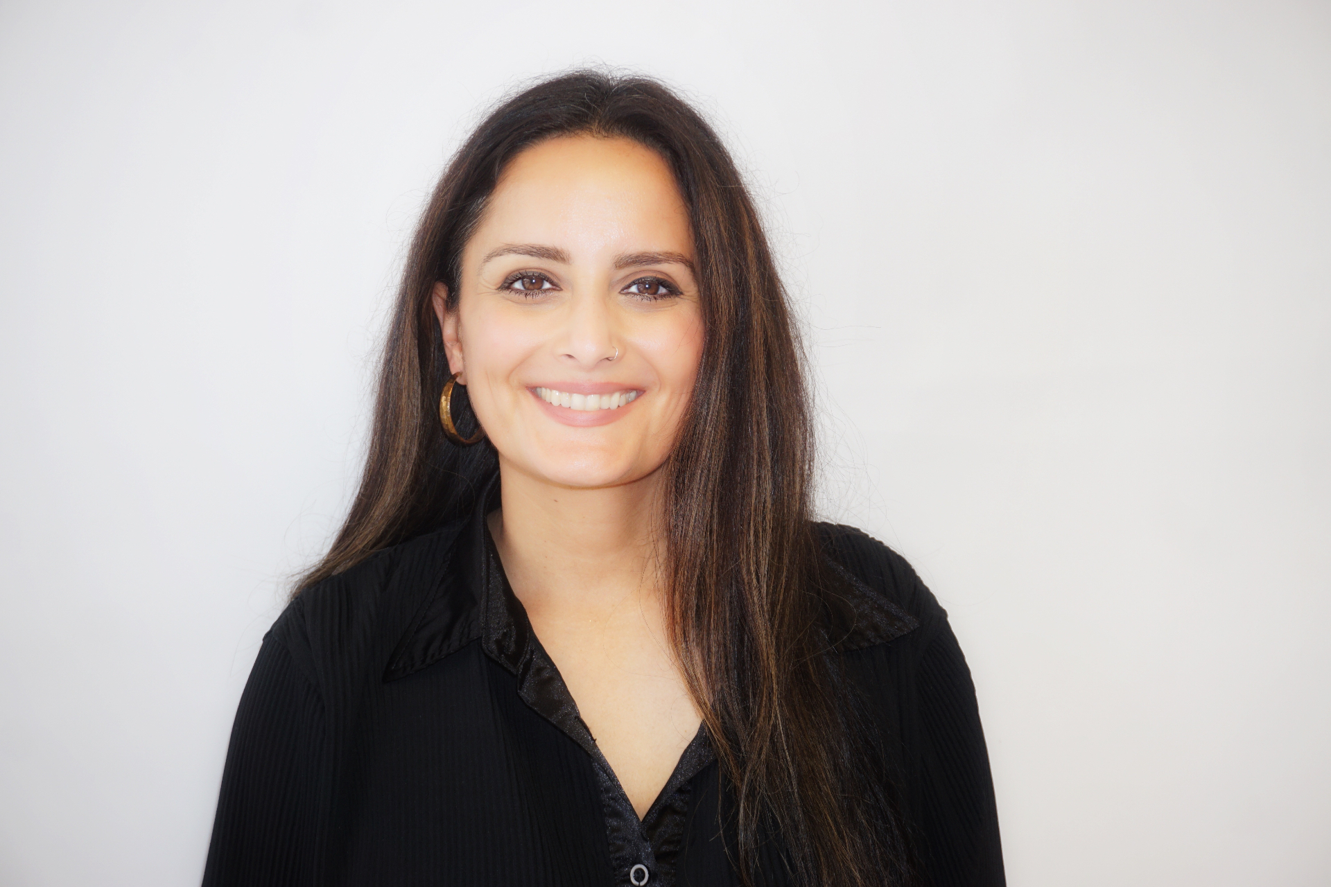 Headshot portrait of Sabrina Siddiqi smiling