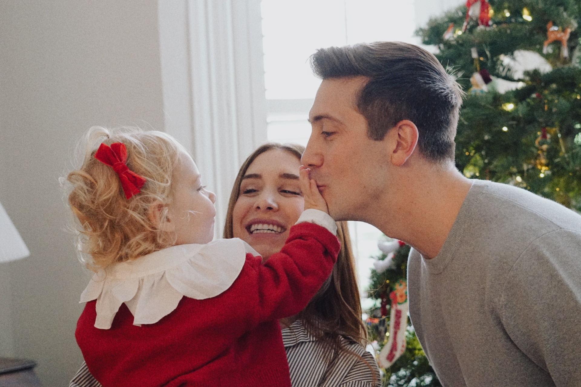 A child kissing her father during The Testa family photoshoot