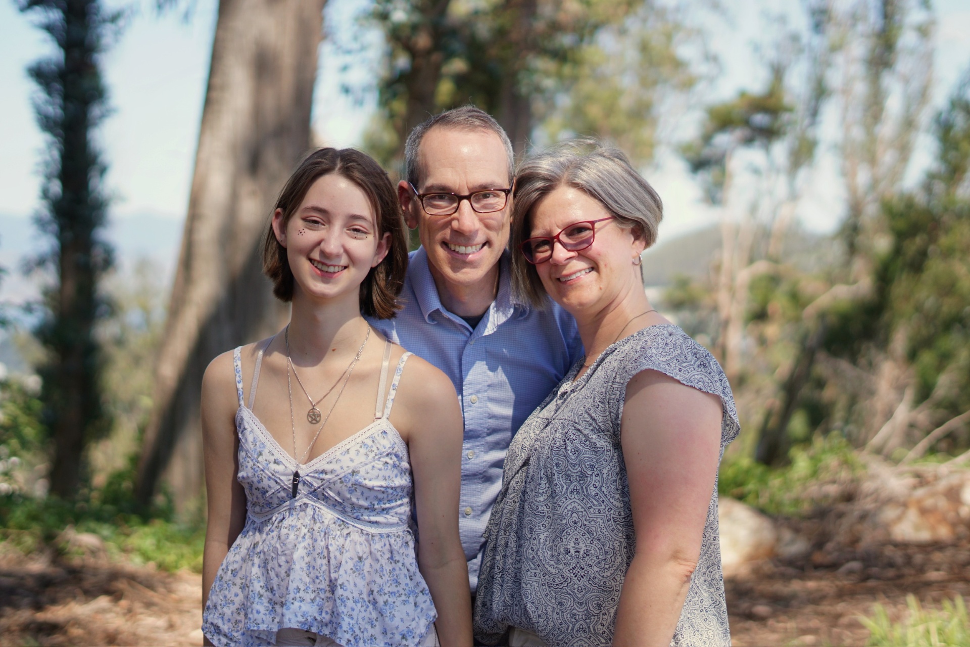 The Trimble family smiling together outdoors in San Francisco